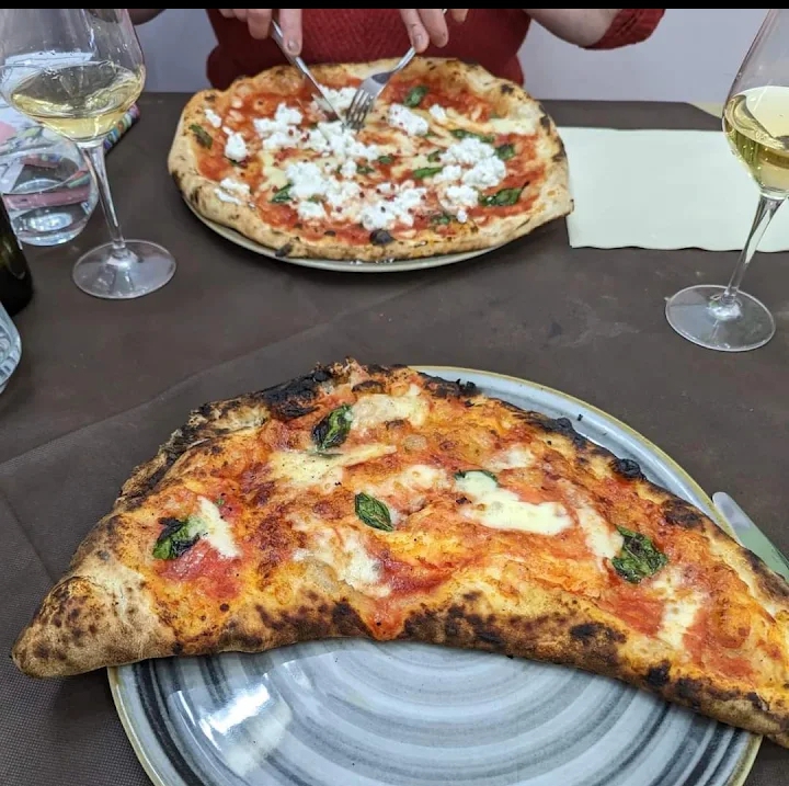 Wood-fired pizza served with white wine